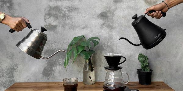 A barista preparing a cup of coffee, carefully pouring hot water over the grounds